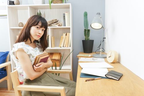 Young woman reading a book at room